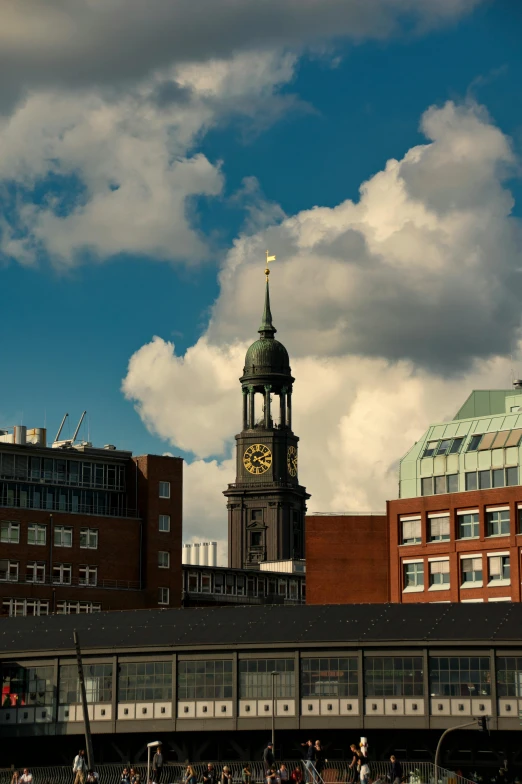 a group of people walking across a bridge with a clock tower in the background, inspired by Thomas Struth, unsplash, modernism, big smoke clouds visible, on a rooftop, chesterfield, neoclassical tower with dome