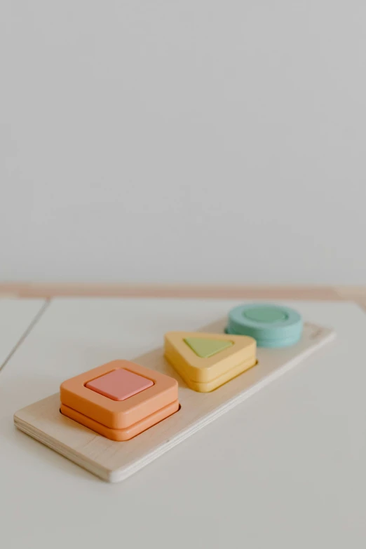 a close up of a plate of food on a table, a jigsaw puzzle, unsplash, visual art, wooden art toys, muted color. minimalist, pastels colours, three dimensions