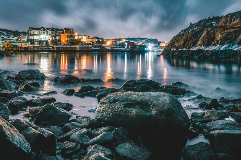 a large body of water surrounded by rocks, by Jesper Knudsen, pexels contest winner, nightime village background, cornwall, thumbnail, multiple stories