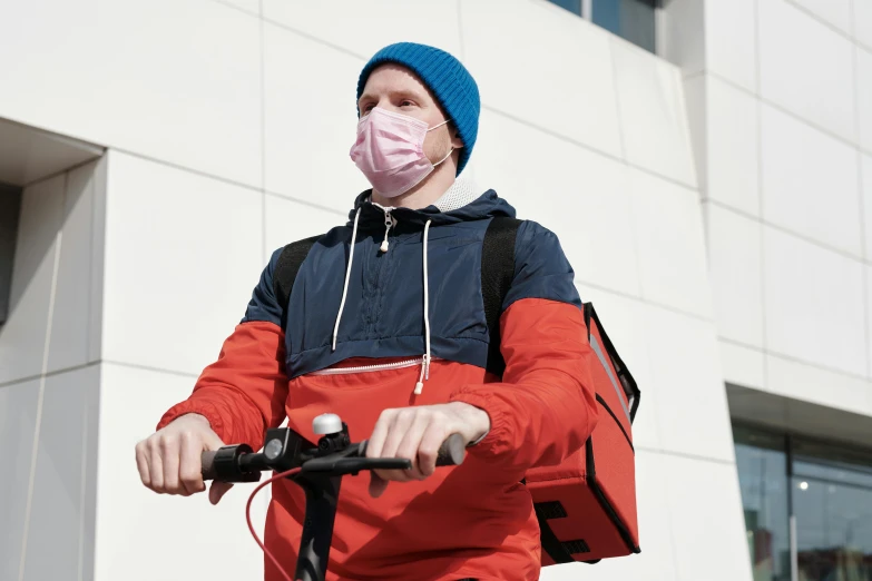 a man on a scooter wearing a face mask, by Carey Morris, trending on pexels, happening, avatar image, healthcare, he‘s wearing a red neckerchief, a man wearing a backpack