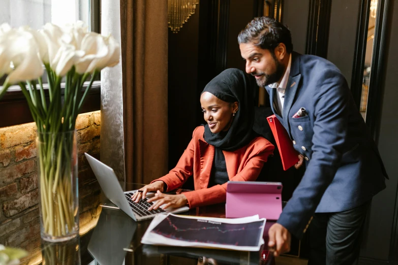 a man and a woman looking at a laptop, by Julia Pishtar, pexels contest winner, hurufiyya, wearing robes and neckties, african ameera al taweel, thumbnail, high class