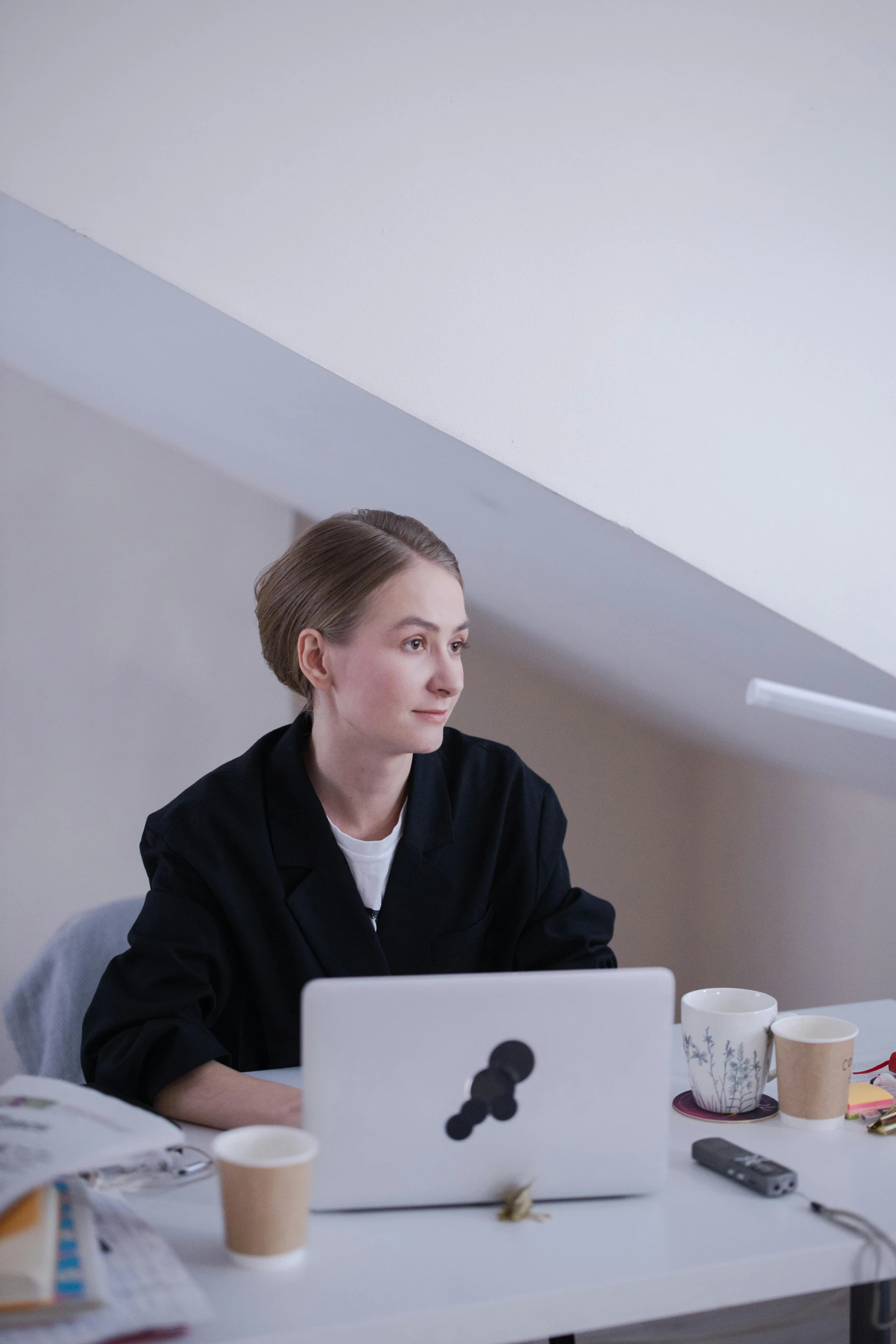 a woman sitting at a desk in front of a laptop computer, inspired by Alexander Roslin, pexels contest winner, low quality footage, profile image, russian academic, slightly minimal