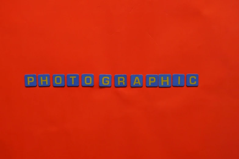 the word photography spelled in blue letters on a red background, ortographic, mcu photograph, colour photography, phograph