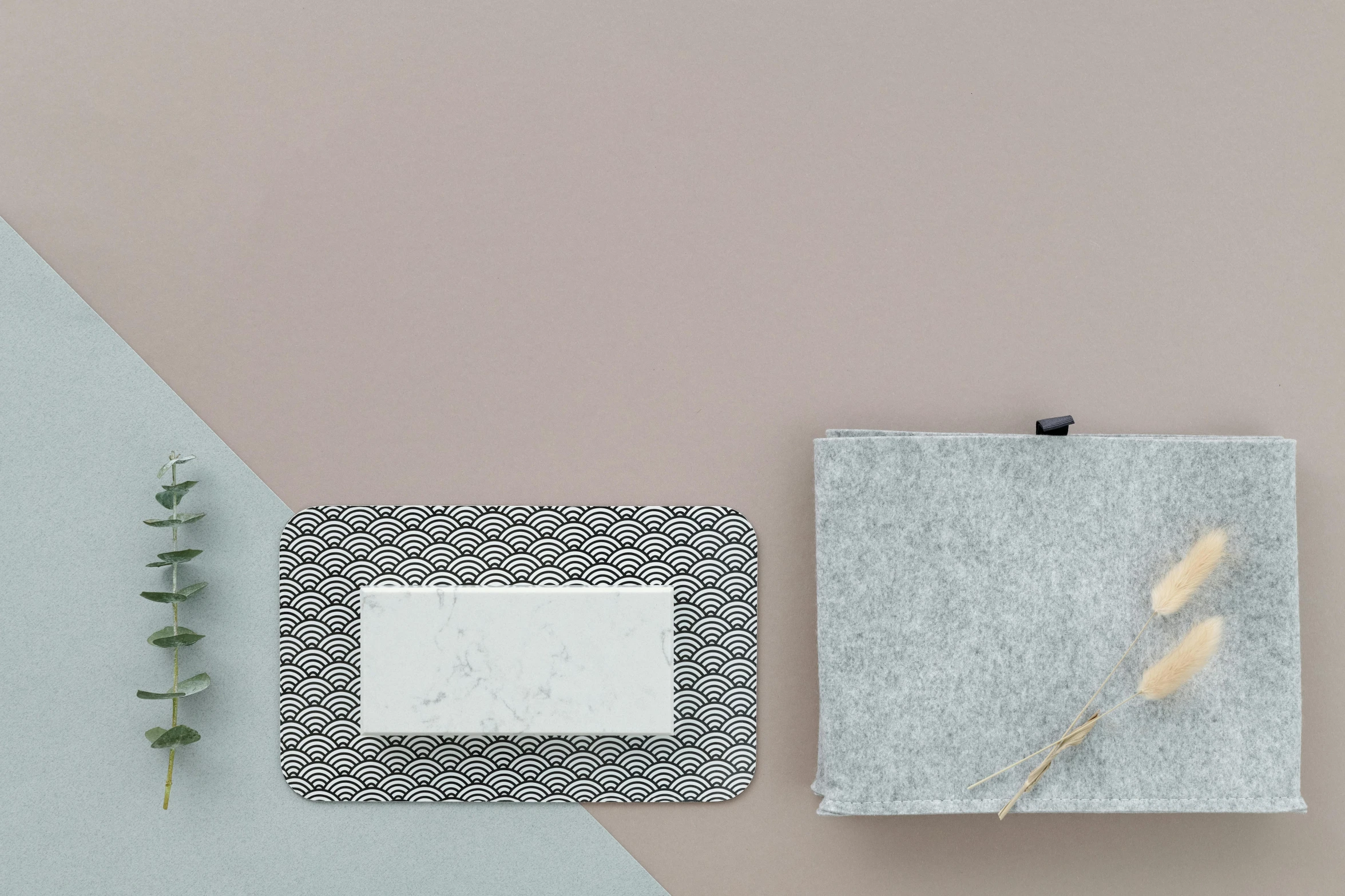 a piece of paper sitting on top of a table next to a plant, inspired by Frederick Hammersley, minimalism, granite, lacey accessories, sakura, grey