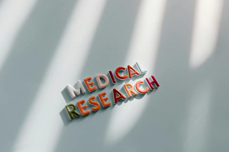 a medical research logo on a white surface, trending on pexels, photo for a magazine, typography, taken in the late 2010s, multi-part