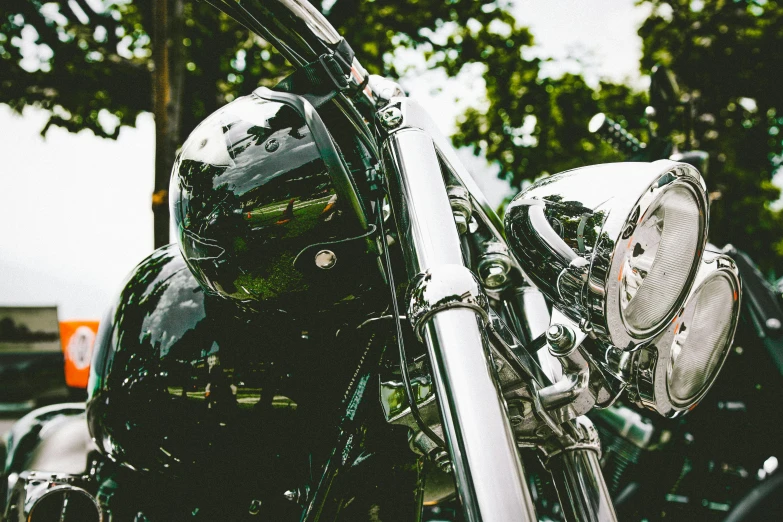 a close up of a motorcycle with a helmet on, pexels contest winner, chrome cathedrals, a green, shiny silver, 🚿🗝📝