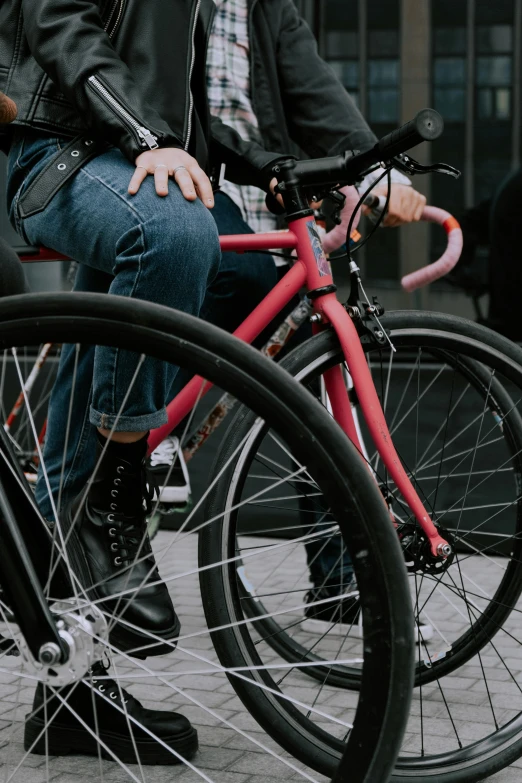 a man sitting on top of a red bike, zoomed in, pink, legs visible, less detailing