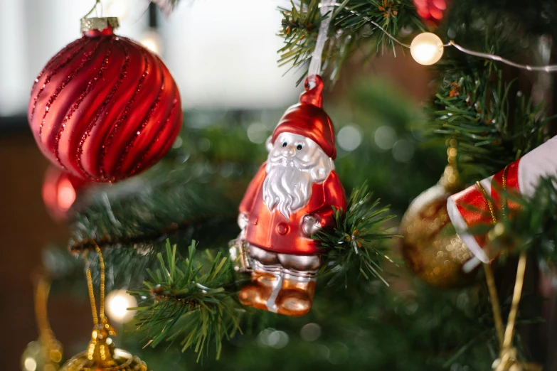 a close up of a christmas tree with ornaments, inspired by Ernest William Christmas, pexels, gnome, sitting on santa, glass bulbs, brown