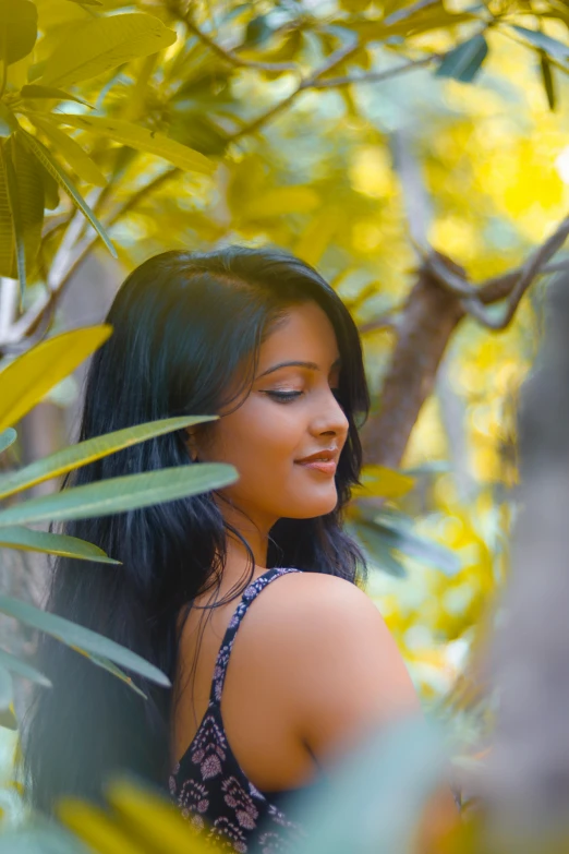 a woman standing in a tree with her eyes closed, by Max Dauthendey, pexels contest winner, sunny leone, with beautiful exotic, back, lush foliage