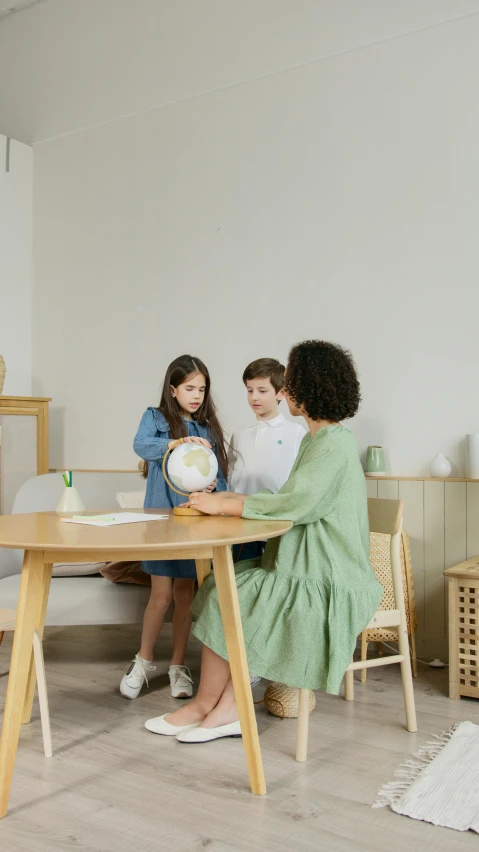 a group of children sitting around a wooden table, furniture, high-quality photo, thumbnail, teaching