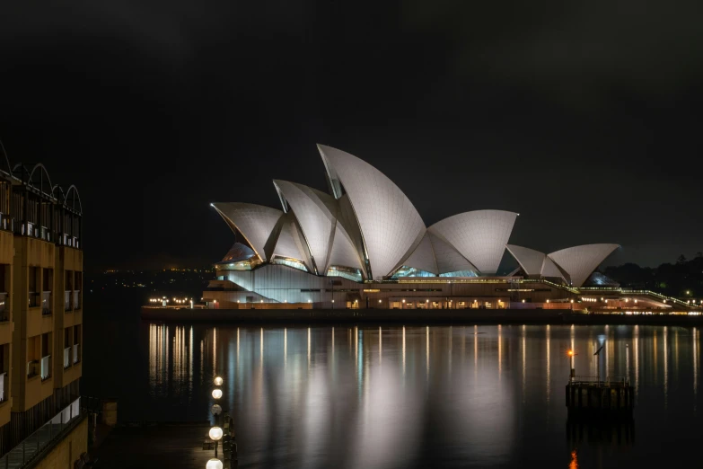 the sydney opera house lit up at night, pexels contest winner, australian tonalism, 8k resolution”, hyperrealism”, minimalist, dramatic”