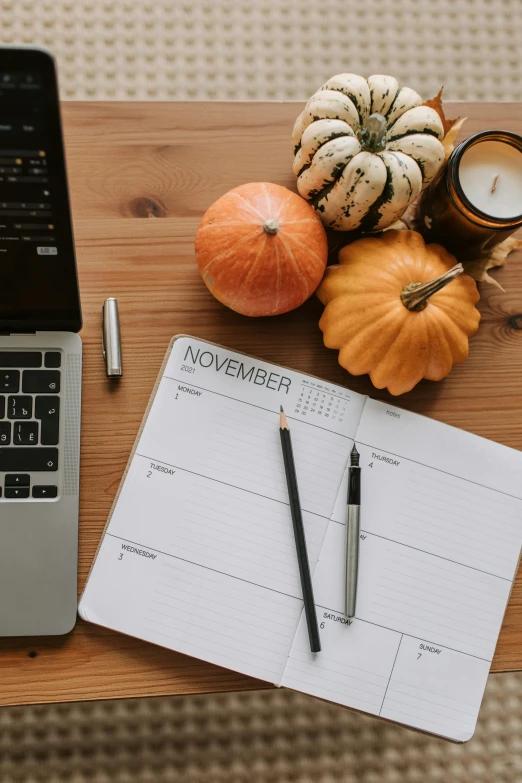 a laptop computer sitting on top of a wooden table, by Carey Morris, trending on pexels, happening, pumpkins, planner stickers, square, 15081959 21121991 01012000 4k