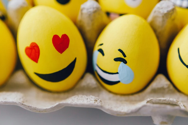 a carton of eggs with smiley faces painted on them, a cartoon, trending on pexels, yellow gemstones, new emoji of biting your lip, community celebration, smiling spartan