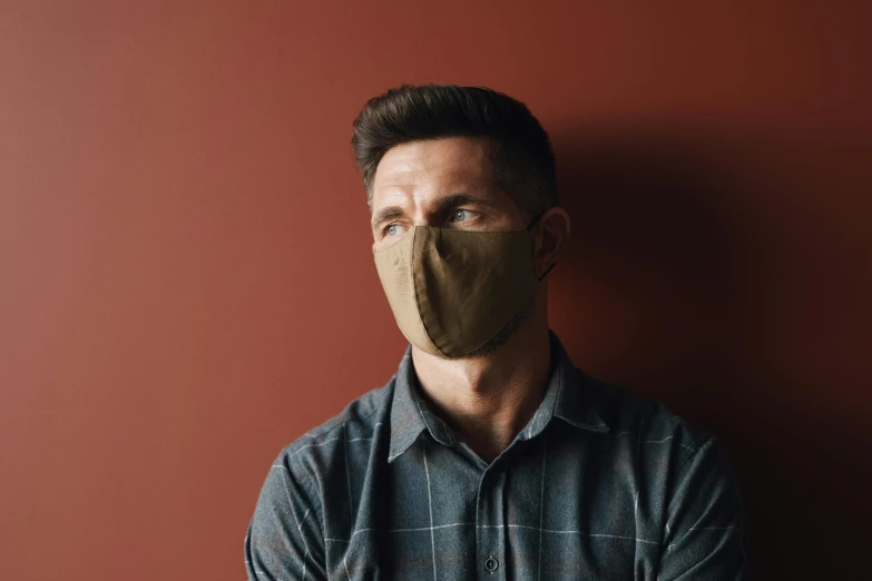 a man with a mask on his face, brown, fan favorite, 60mm portrait, commercial