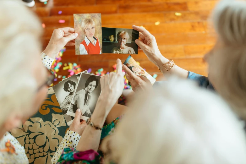 a group of people taking pictures with their cell phones, a polaroid photo, by Julia Pishtar, elderly, precious moments, woman holding another woman, celebration