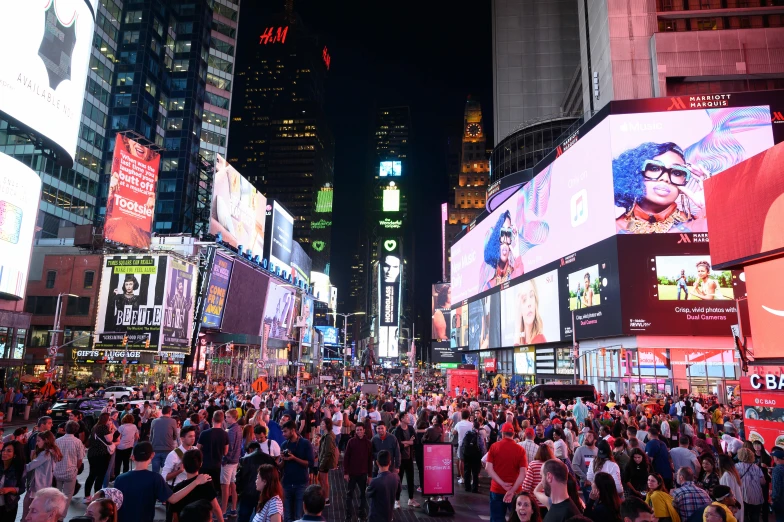 a crowded city street filled with lots of people, a picture, new york city at night, square, thumbnail, billboard image