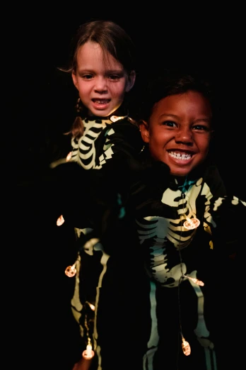 a couple of kids standing next to each other, an album cover, inspired by Frans Hals, flickr, glowing bones, diverse costumes, closeup portrait shot, full of joy