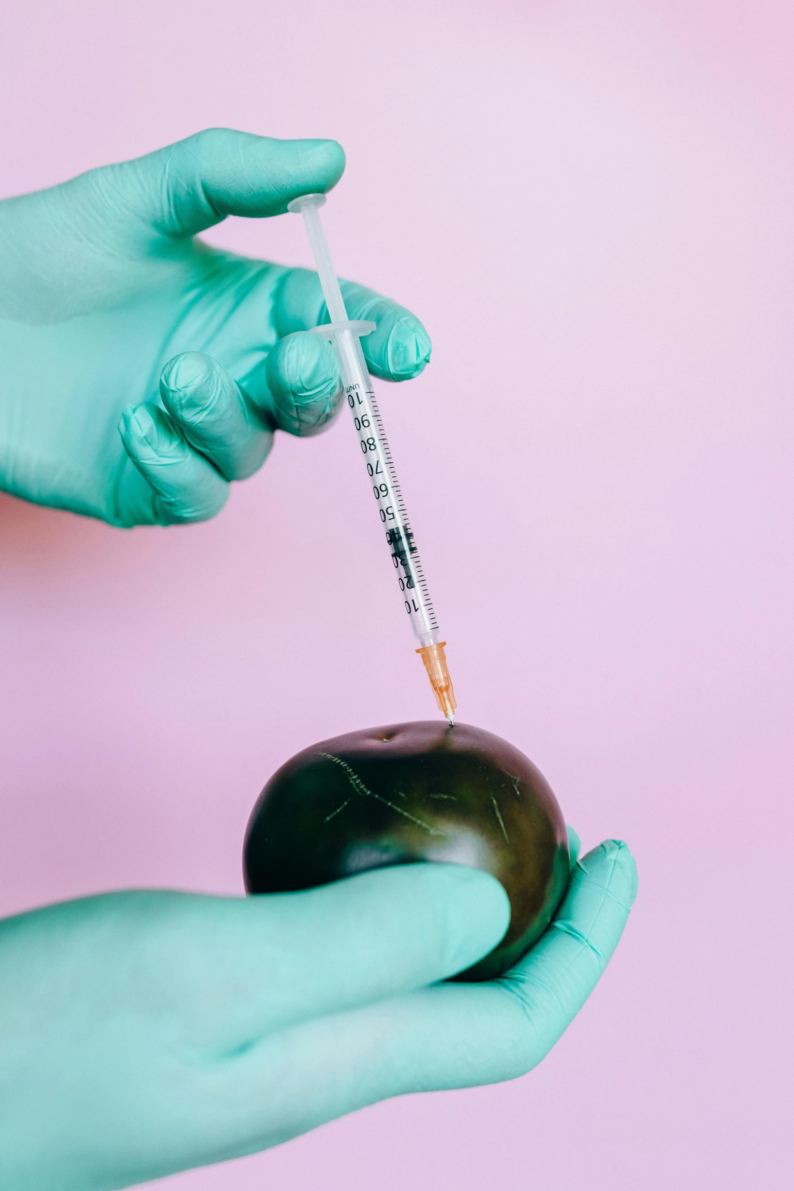 a person in blue gloves is holding an apple, an album cover, by Julia Pishtar, shutterstock, holding syringe, here is one olive, aerial iridecent veins, instagram picture