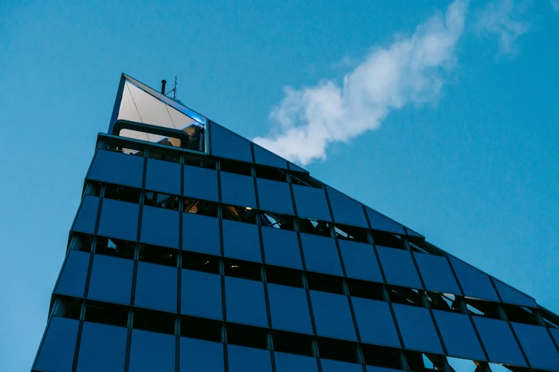 a very tall building with a lot of windows, pexels contest winner, brutalism, smoke billowing, blue skies, pyramid, te pae