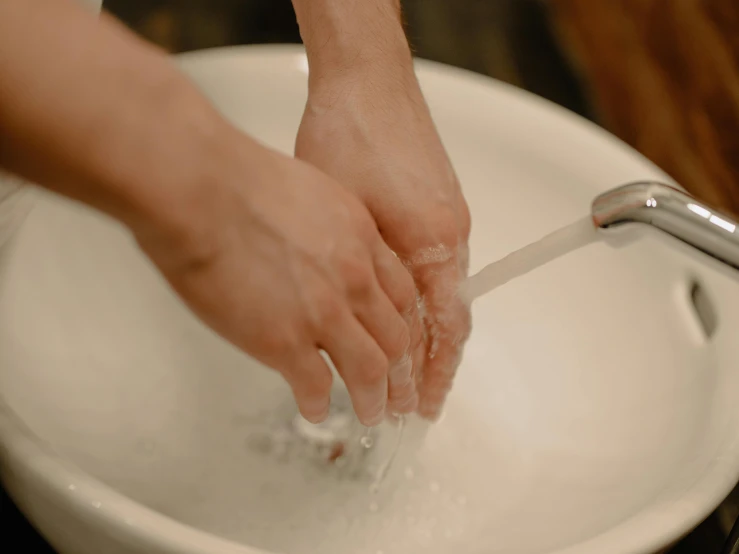 a person washing their hands in a bowl, pexels contest winner, fan favorite, manly, youtube thumbnail, 33mm photo