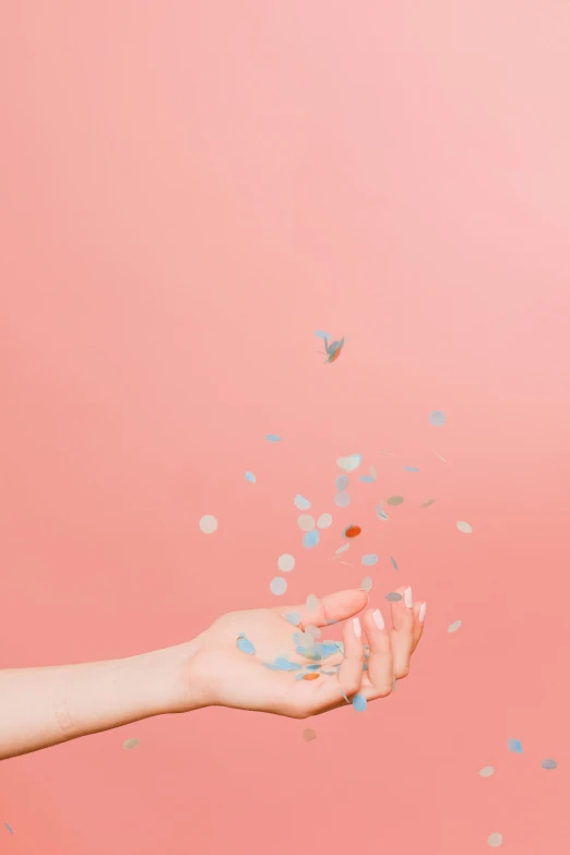 a woman's hand reaching for confetti on a pink background, pexels contest winner, aestheticism, clemens ascher, 15081959 21121991 01012000 4k, synthetic bio skin, flying debris