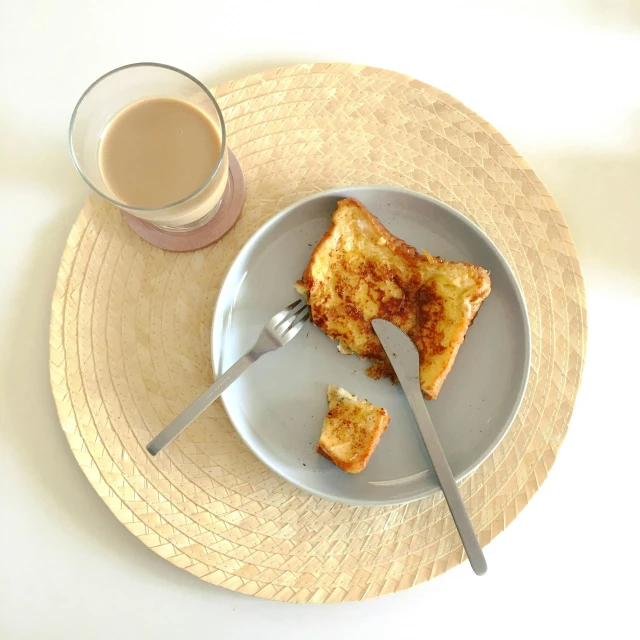 a plate with a piece of toast on it next to a cup of coffee, by Romain brook, pexels, minimalism, square, moroccan, gif, with a straw