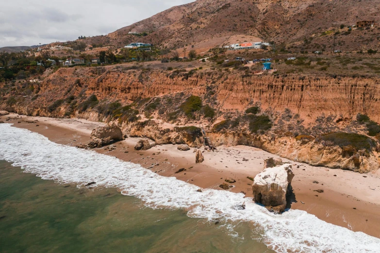 a large body of water next to a sandy beach, a digital rendering, by Ryan Pancoast, unsplash, malibu canyon, landslides, slide show, settlement