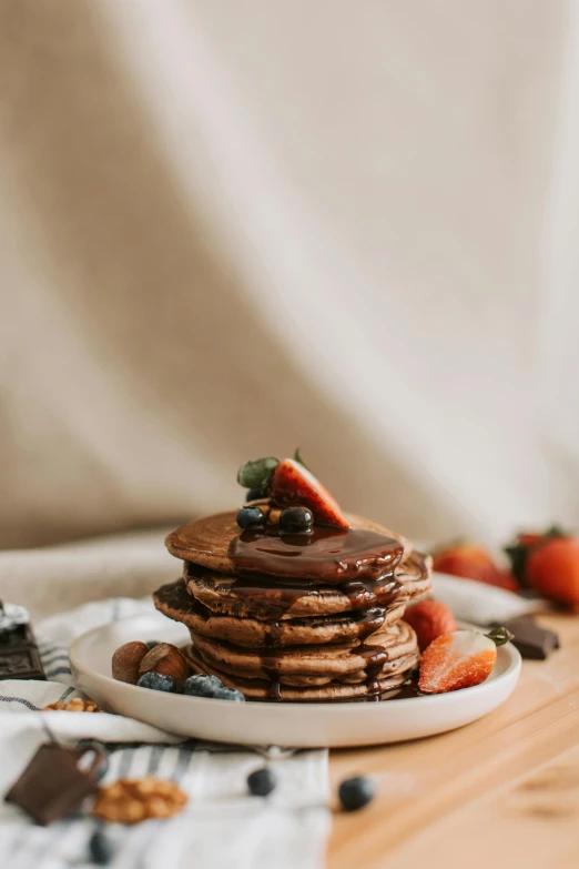 a stack of pancakes sitting on top of a white plate, by Julia Pishtar, fully chocolate, organic, fruit, 6 pack