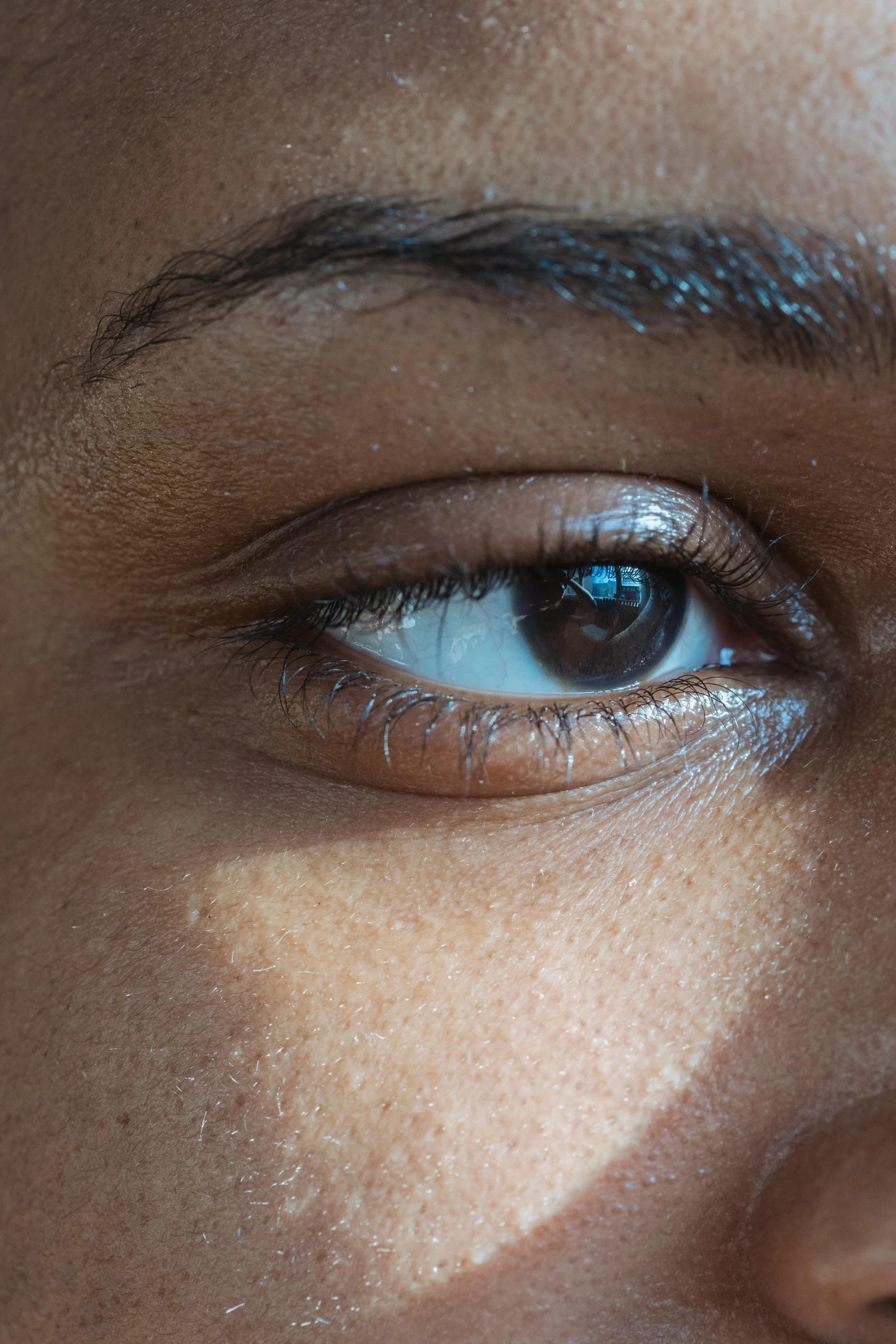 a close up of a woman's face with a toothbrush in her mouth, an album cover, inspired by Gordon Parks, trending on unsplash, hyperrealism, macro photo of a human eye, light-brown skin, blue reflective eyes, soft portrait shot 8 k