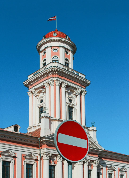 a red and white building with a sign in front of it, by Sven Erixson, shutterstock, art nouveau, neoclassical tower with dome, фото девушка курит, square, color photo