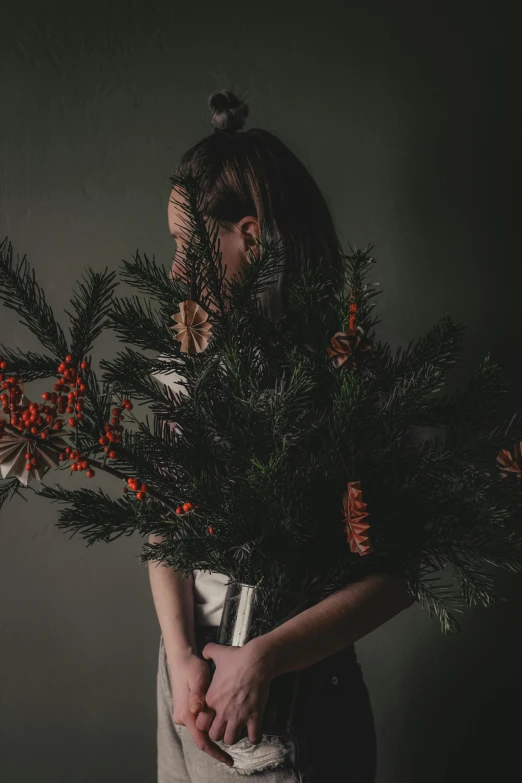 a woman holding a bunch of pine branches, an album cover, inspired by Elsa Bleda, unsplash contest winner, humanoids overgrown with flowers, christmas tree, profile image, ignant