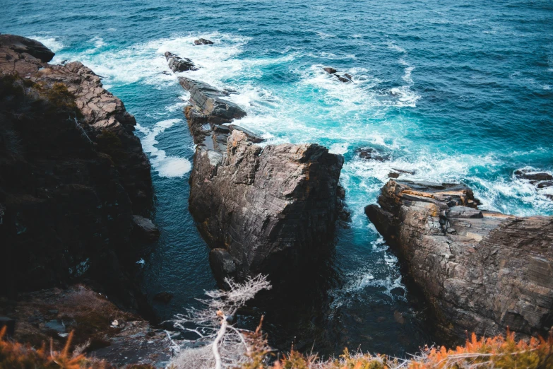 a view of the ocean from the top of a cliff, by Ryan Pancoast, pexels contest winner, jagged rocks, wild water, thumbnail, half length shot