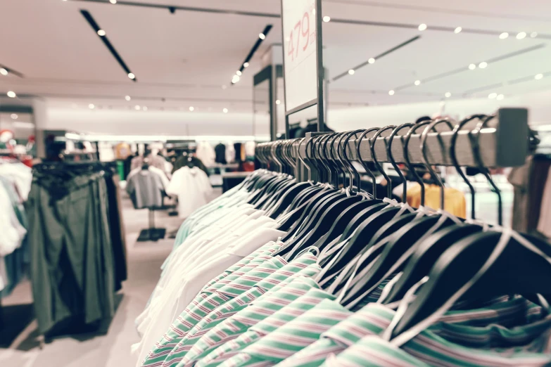 a rack of clothes in a clothing store, by Matija Jama, trending on unsplash, mall background, multiple stories, leaked image, zoomed in