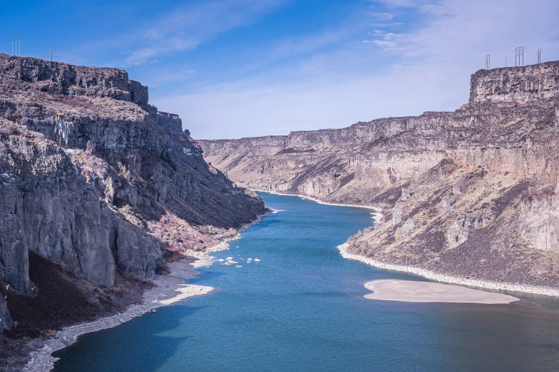 a large body of water surrounded by mountains, by Doug Wildey, pexels contest winner, hurufiyya, canyon topography, drumheller, thumbnail, steep cliffs