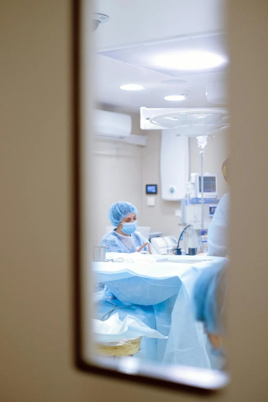 a view of a surgery room through a mirror, happening, masked person in corner, profile image, operation, blue