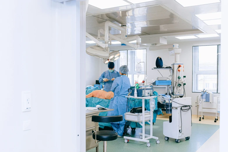 a group of doctors working on a patient in an operating room, by Daniel Lieske, pexels, long shot from the back, lachlan bailey, panoramic shot, profile image