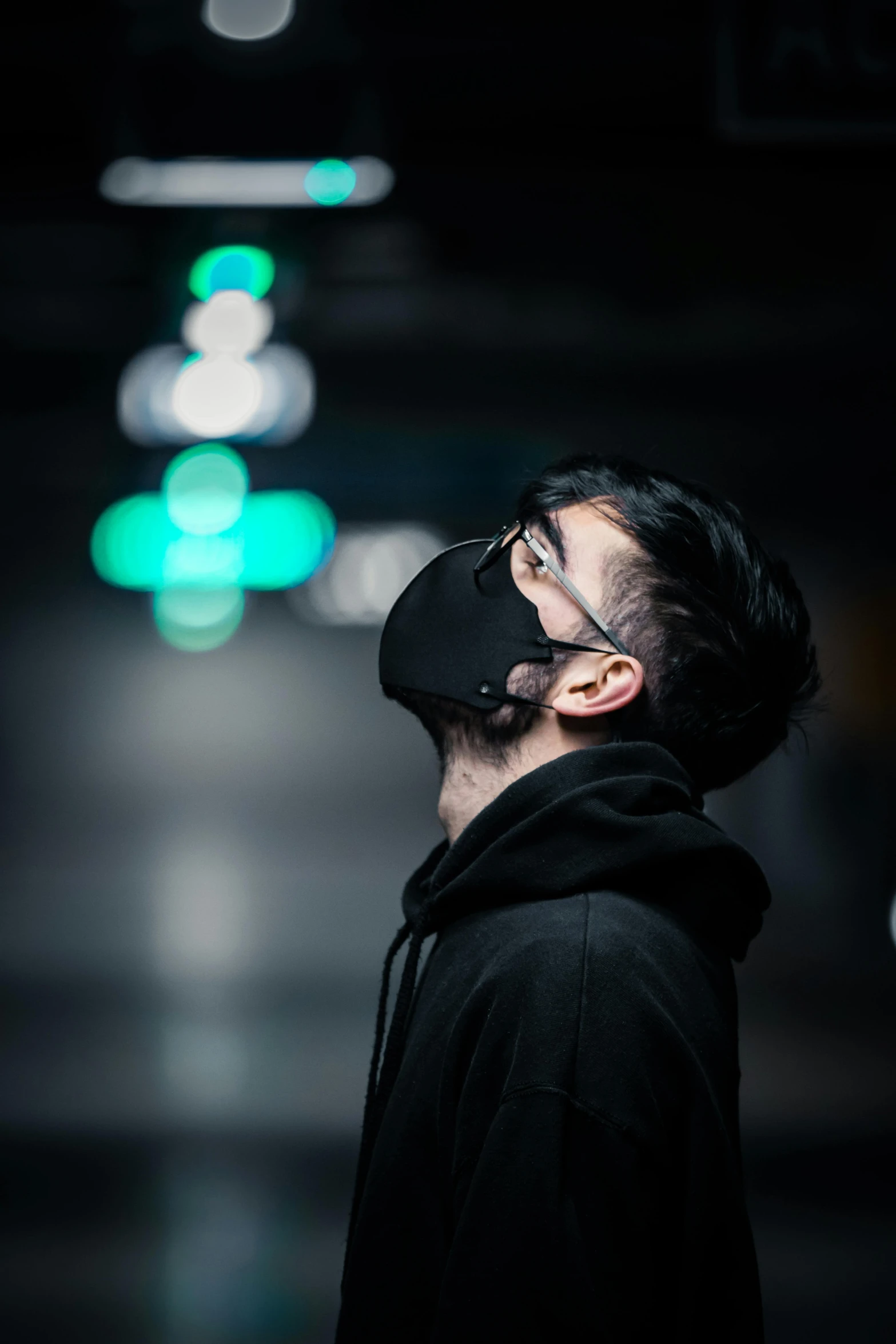 a man wearing a face mask in a dark room, by Beeple, trending on pexels, hyperrealism, side view future coder man, asian male, trending on r/techwearclothing, distant expression