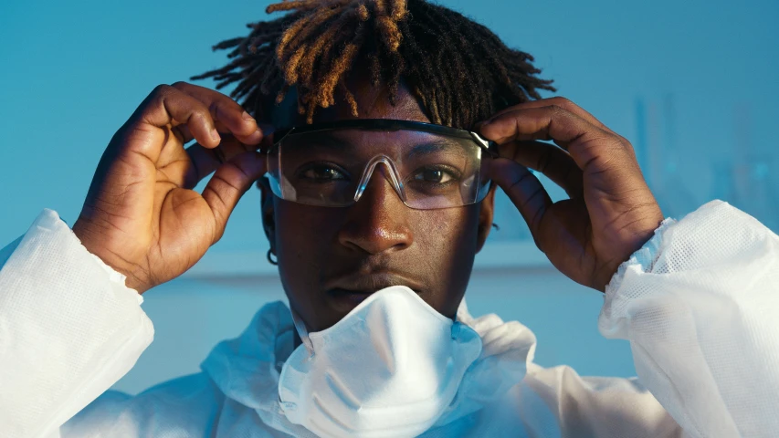 a close up of a person wearing glasses, trending on pexels, afrofuturism, wearing a lab coat, cleaning future, 2 1 savage, from below