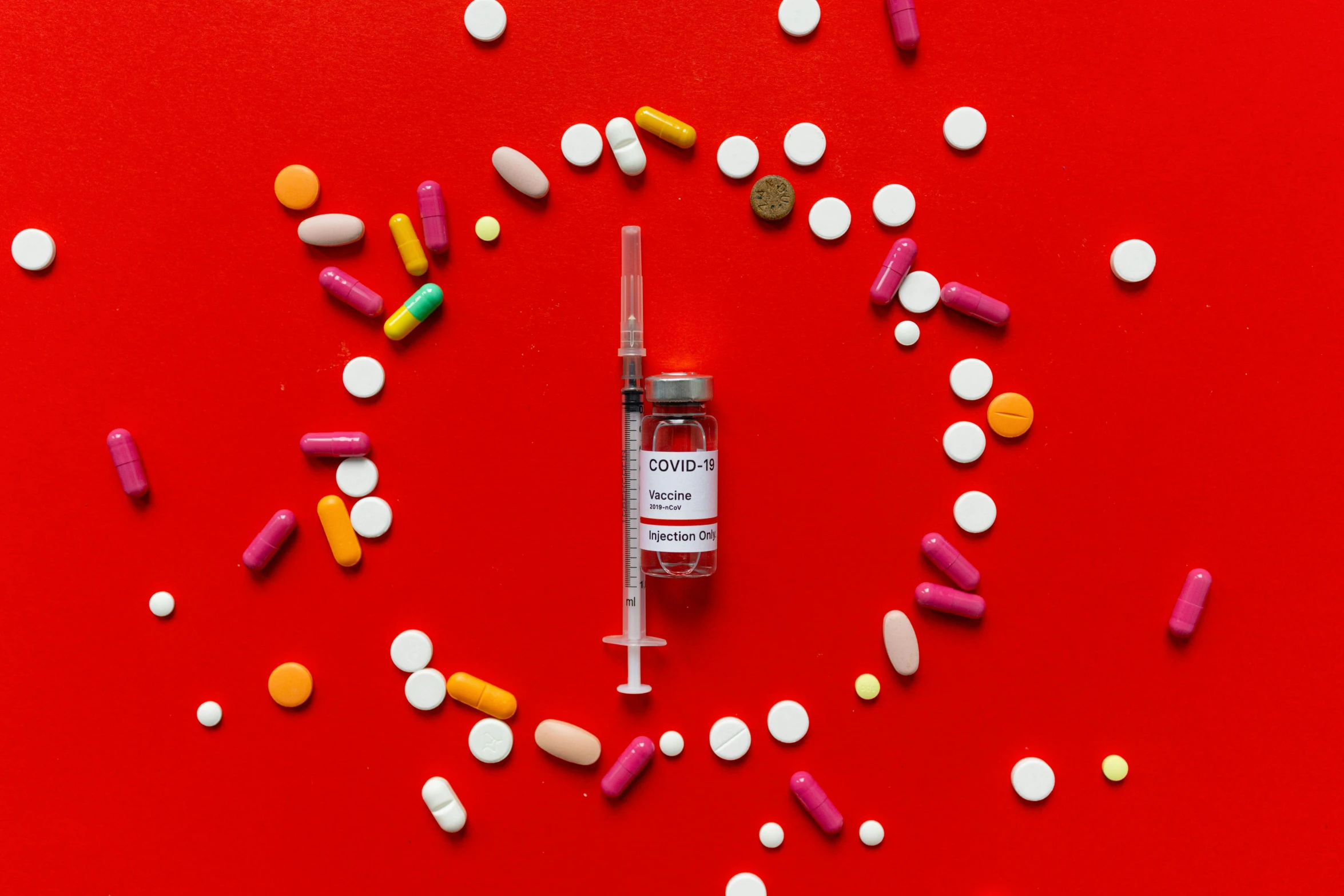 a syll filled with colorful pills on a red background, inspired by Damien Hirst, pexels contest winner, syringe, 🦩🪐🐞👩🏻🦳, beauty is a virus, white and red color scheme