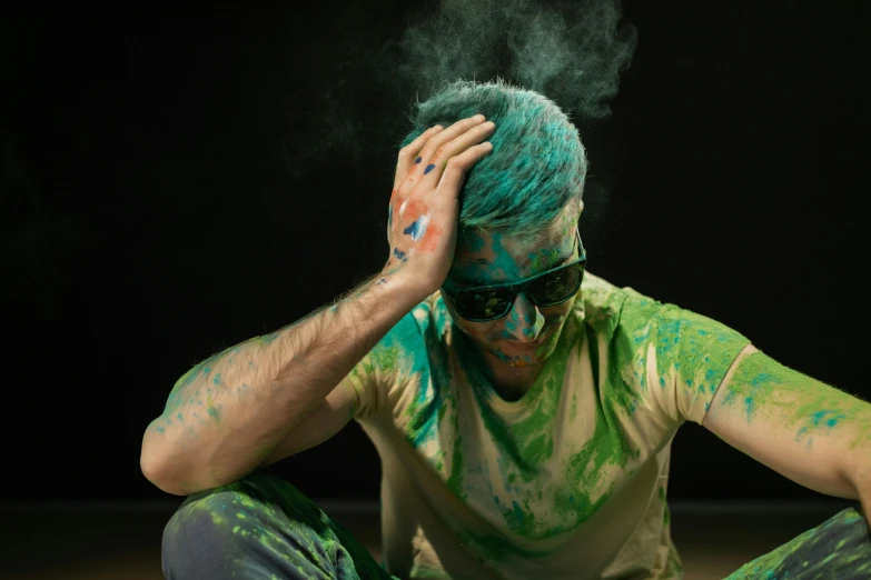 a man sitting on the floor covered in green and blue paint, disgust, avatar image, green shades, multi - coloured