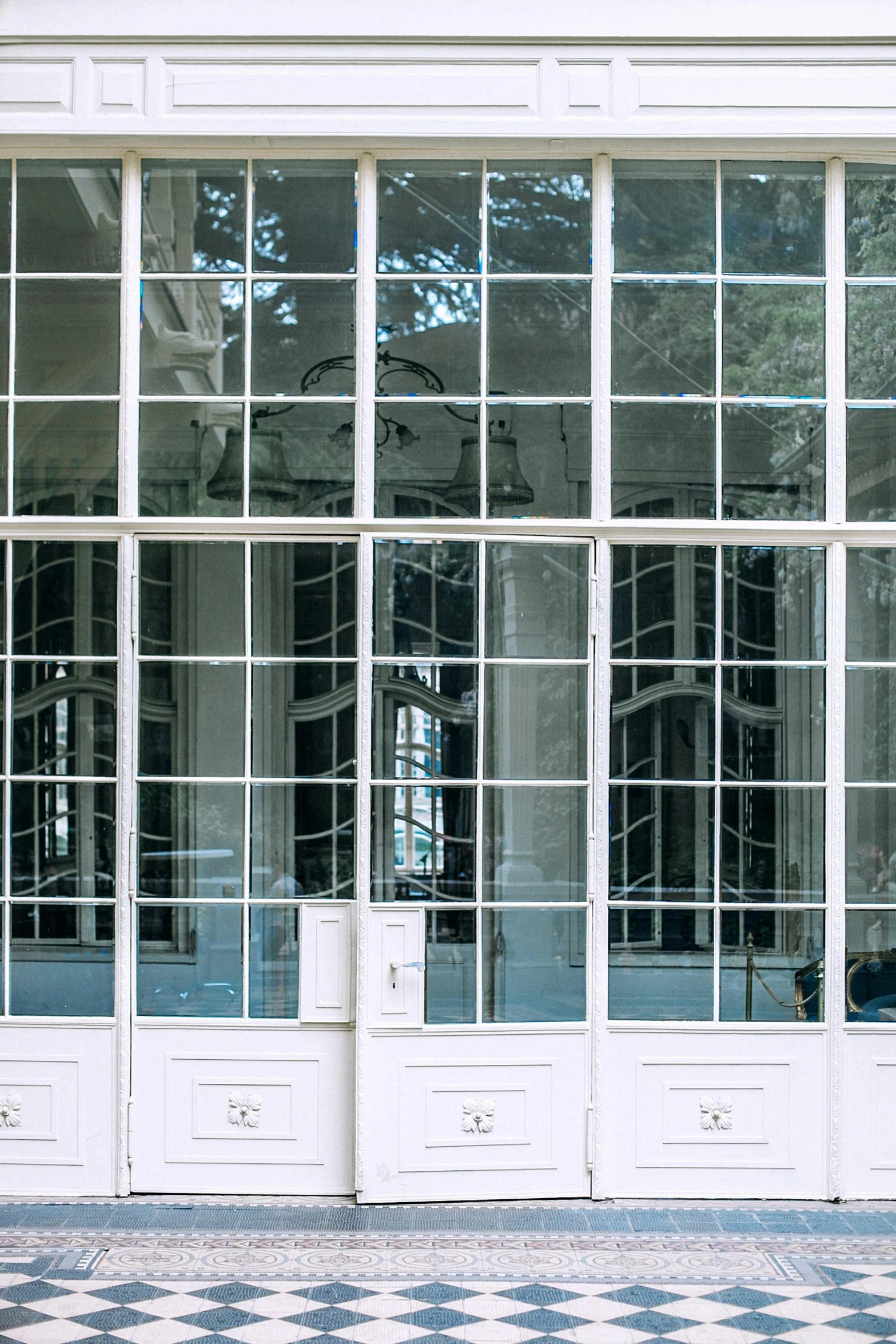 a red fire hydrant sitting in front of a building, an album cover, unsplash, neoclassicism, glass greenhouse, big mirrors, white panels, french door window