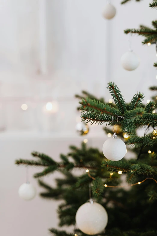 a christmas tree with white balls hanging from it, pexels, baroque, soft white glow, full product shot, multiple stories, scandinavian