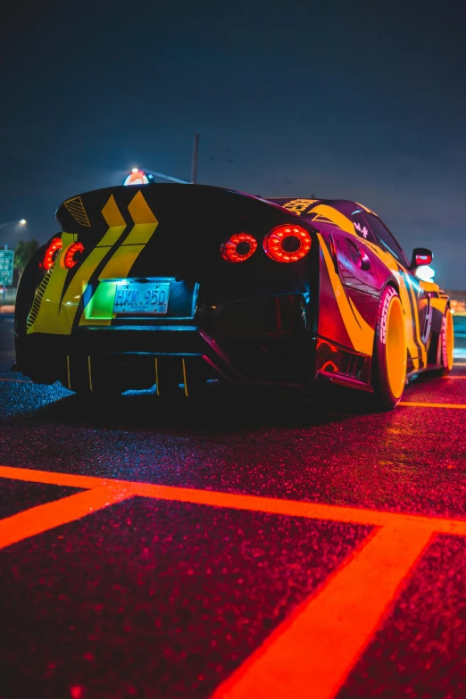 a car parked on the side of the road at night, by Austin English, pexels contest winner, hypermodernism, nissan gtr r 3 4, samurai vinyl wrap, vibrant color, on a racetrack