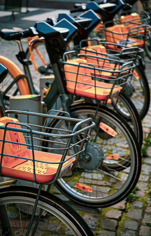 a row of bicycles parked next to each other, a digital rendering, by Jacob van Utrecht, pexels, happening, orange details, square, closeup photograph, platforms