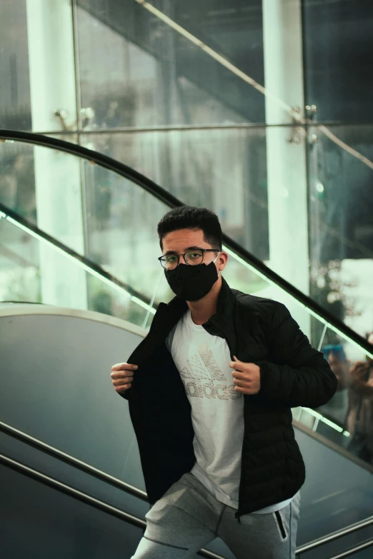 a man wearing a face mask on an escalator, pexels contest winner, wearing black rimmed glasses, wearing adidas clothing, asher duran, actual photo