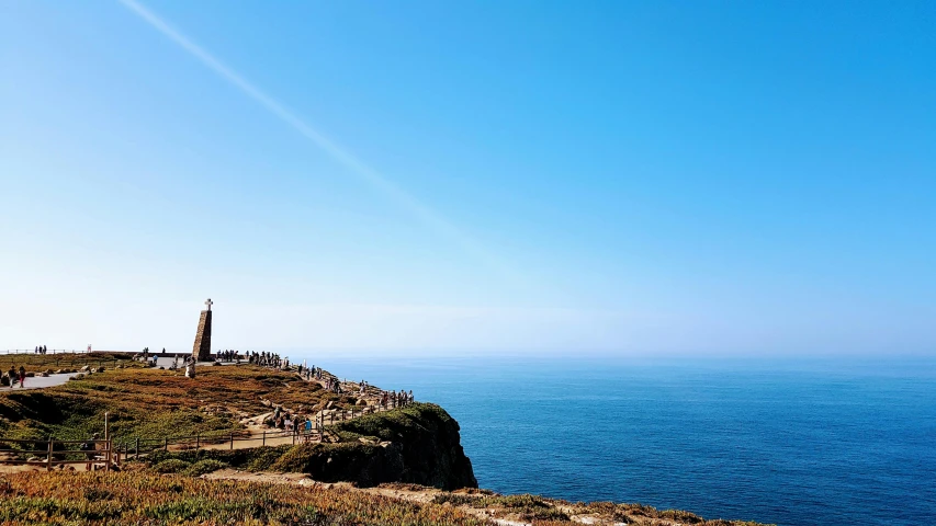 a lighthouse sitting on top of a cliff next to the ocean, pexels contest winner, happening, light blue clear sky, portugal, thumbnail, marsden