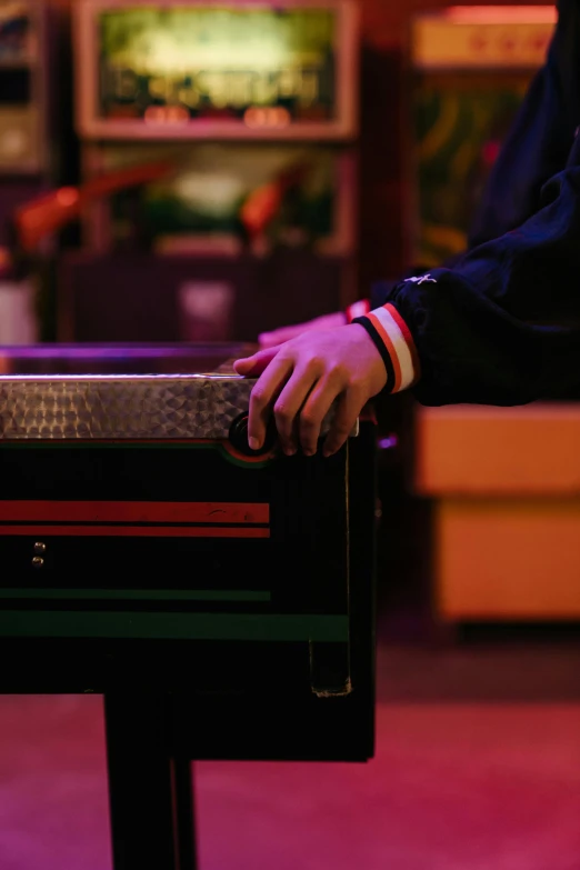 a close up of a person playing a video game, an album cover, by Elsa Bleda, trending on unsplash, in a bar, carrying a tray, black steel with red trim, mellotron