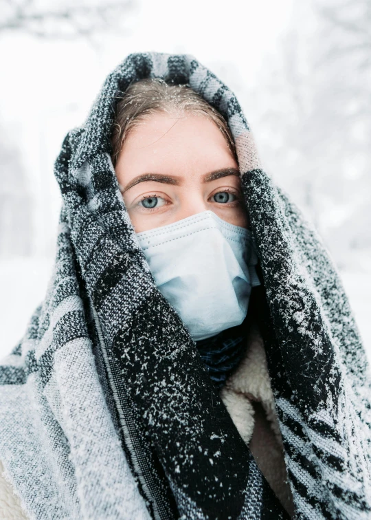 a woman wearing a face mask in the snow, an album cover, trending on pexels, medical, 😭🤮 💔, cold grey eyes, scientific photo