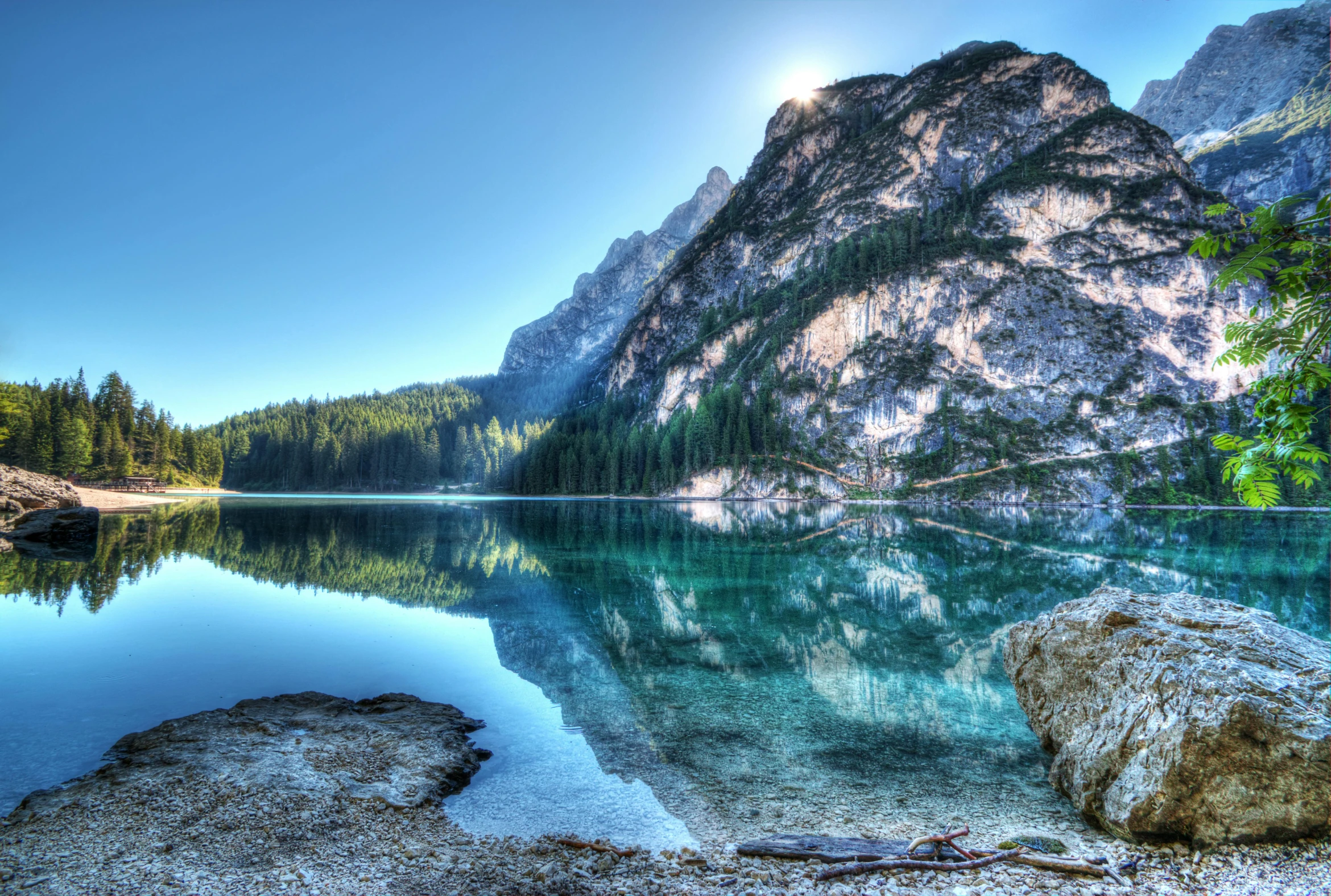 a lake with a mountain in the background, by Bernardino Mei, pexels contest winner, clear and sunny, tonemapped, teal landscape, reflective light