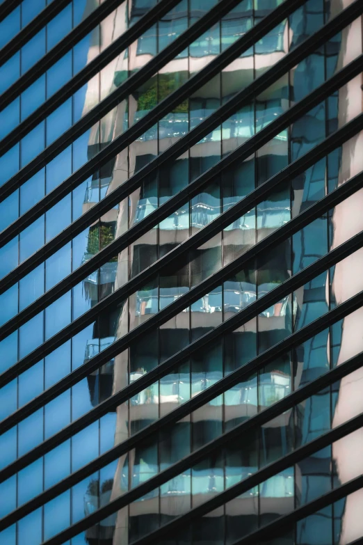 a tall building is reflected in the windows of another building, a picture, inspired by Ned M. Seidler, pexels contest winner, square lines, blue and black, bangkok, medium closeup shot